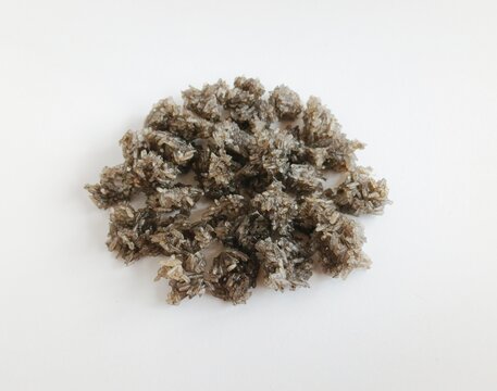 Close-up of anchovy rice crackers, known as rengginang teri, a traditional Indonesian savory snack made from glutinous rice and small anchovy fish. 