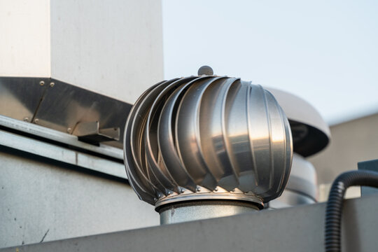 Close-up of a rotating turbine vent on a building rooftop in Gdansk