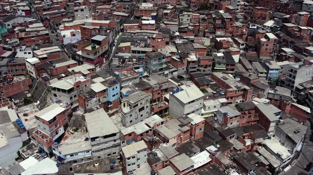 Aerial drone footage reveals sprawling favela community with densely packed houses and narrow streets