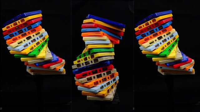Colorful spiral shape with gradient colors made of vintage audio cassette creating vibrant abstract DNA pattern and mesmerizing abstract on dark background
