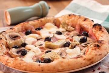 Delicious homemade pizza sits invitingly on a plate, adorned with fresh mushrooms, artichokes, and olives. This meal represents warmth and love, perfect for tough financial times