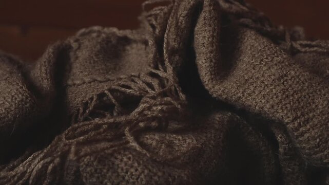 A stack of blankets sits atop a bed, perfect for cozying up or adding a decorative touch