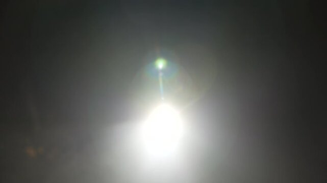 Bright green spotlights cut through the dark atmosphere of an empty stage or venue. The dynamic beams create circular patterns on the floor, evoking an energetic mood for a concert or live event.
