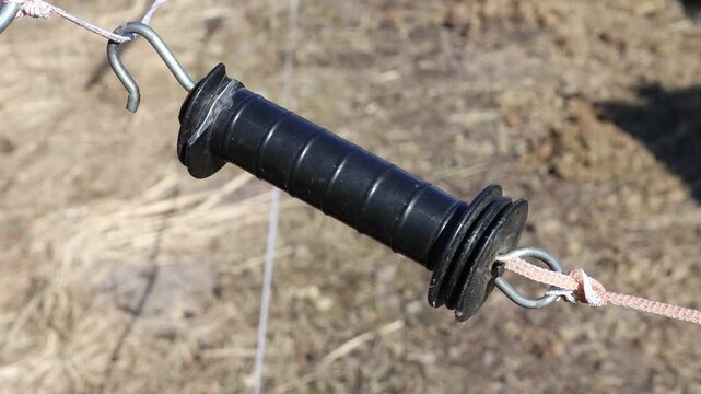 A mysterious black object suspended from a rope, perfect for use in scenes where you need to create intrigue or mystery