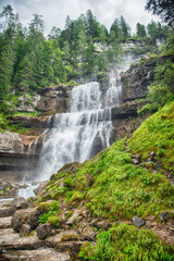 Obraz premium Water cascading down Vallesinella Falls in the Dolomites, Italy
