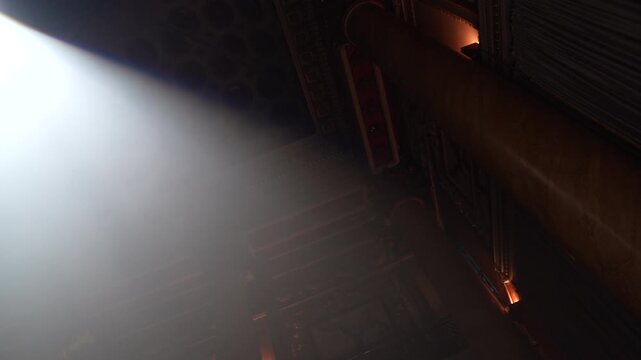 Bright green spotlights cut through the dark atmosphere of an empty stage or venue. The dynamic beams create circular patterns on the floor, evoking an energetic mood for a concert or live event.
