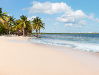 Obraz premium Paradise Sunny beach with palms and turquoise sea. Amazing rainbow in the background Summer vacation and tropical beach concept - Cancun, Mexico