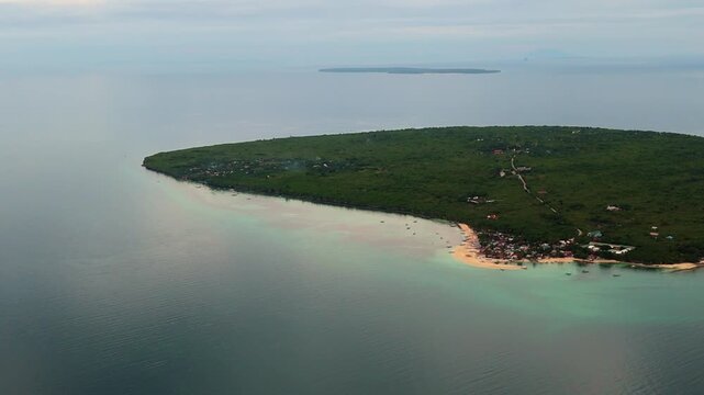 Cinematic drone shot of the turquoise waters and lush tropical greenery of Virgin Island, a famous day trip destination near Bantayan Island