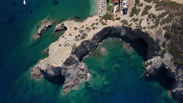 Aerial view of karavostasi beach and its cliffs in rethymno, crete, with clear turquoise water