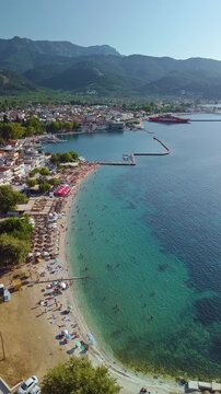 Aerial View of Limenas Beach with People Swimming in Thasos Greece