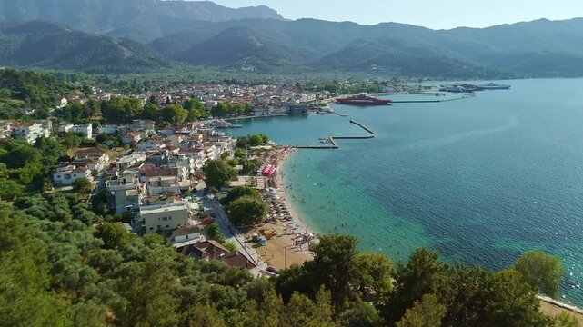 Aerial View of Limenas Beach with People Swimming in Thasos Greece