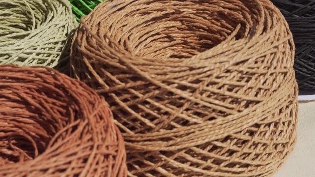 Close-up of raffia skeins. ECO raw material. Multi-colored raffia balls ready for knitting.