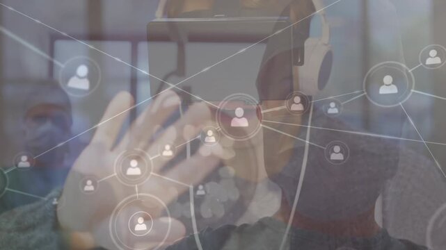 Network of profile icons over caucasian female surgeon against woman wearing vr headset