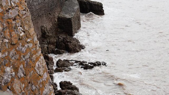 sea ​​waves crashing against cliffs in England