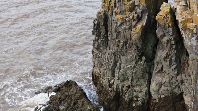 sea ​​waves crashing against cliffs in England