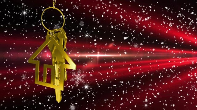 Red beam sweeping gold house keychain starting it rotating and sparkles drifting for marketing