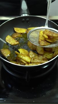 Chef Sizzling Crispy Seasoned Potato Wedges in Frying Pan