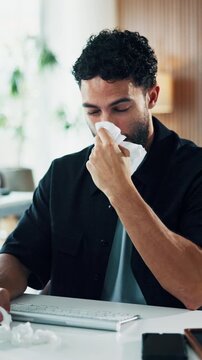 Man, computer and blowing nose in workplace with tissue, flu and sinus infection at marketing agency. Sick, person and employee in office with toilet paper, virus symptoms or desktop for advertising.