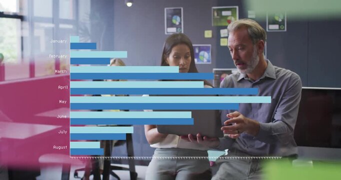 Analyzing data charts on laptop, business professionals in modern office setting