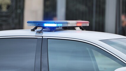 Police patrol car with flashing emergency lights indicating law enforcement presence © Довидович Михаил