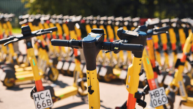 Electric scooters for rental lined up, offering urban mobility and sharing economy transport