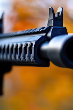 A detailed view of a gun with blurred surroundings