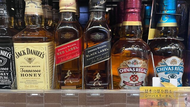 Alcohol bottles featuring Jack Daniel's Tennessee Honey, Johnnie Walker Red Label and Black Label, and Chivas Regal whisky - Japan, August 27, 2025