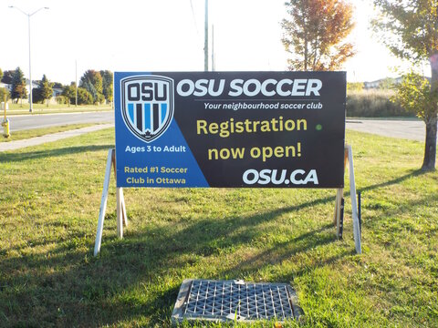 Gloucester, Ontario, Canada &ndash; July 24, 2026: An "OSU Soccer registration" sign stands in a grassy field, advertising local community sports programs for ages three to adult on Blanca St.
