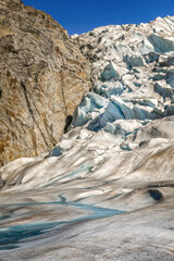 A rock surrounded by glacial ice on the Mendenhall glacier, Alaska