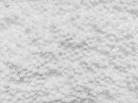 Closeup of white polystyrene foam beads creating dense bumpy textured surface