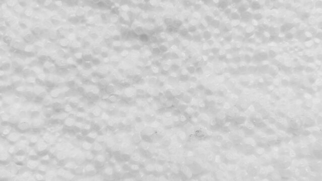 Macro photograph of granular styrofoam pellets forming lightweight expanded texture