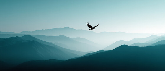 Naklejka premium Eagle soaring high above a misty mountain range