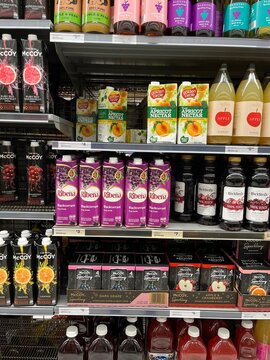 Grocery store shelves stocked with variety of fruit juices including Ribena blackcurrant fruit drink and McCoy sparkling water and fruit juice - Auckland, New Zealand, February 7, 2023