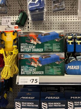 Autohaus Intelligent Battery Charger and bungee straps on shelf display at The Warehouse retail store in Mangere-Otahuhu district - Auckland, New Zealand, February 7, 2023