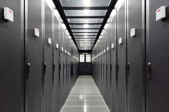Server room corridor with rows of cabinets in a modern data center