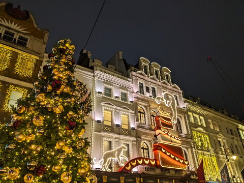 Festive Christmas tree and glowing panther display on the Cartier flagship store in London
