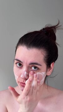 Skin Care Routine. Relaxed Woman Uses Gentle Circular Motions To Moisturize Her Facial Skin Peacefully