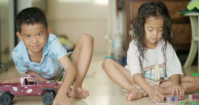 Adorable littl shcool boy enjoy play car toy with block building in cozy room education concept