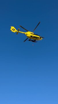 Rescue helicopter in flight recovers the loading winch