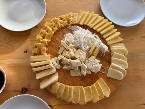 A display of various cheese platters. Round, wooden platter. Kars Boğatepe cheeses, Gruyere and Kashar. Kars T&uuml;rkiye 