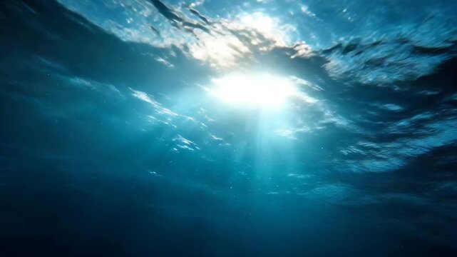 Ocean surface viewed underwater with shimmering light symbolizing calm joy and purity