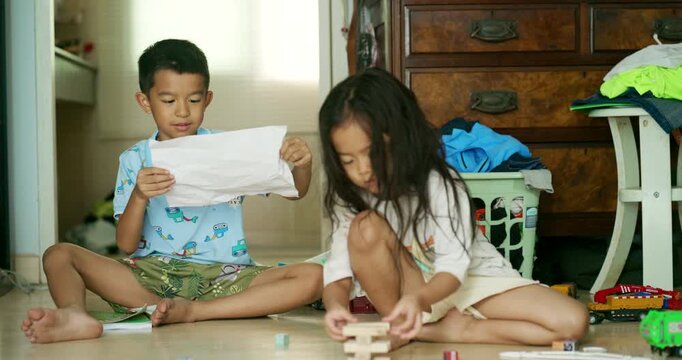 Adorable littl shcool boy enjoy play car toy with block building in cozy room education concept