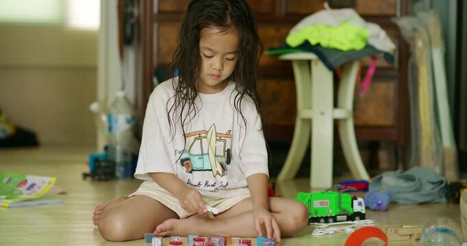 Adorable littl shcool boy enjoy play car toy with block building in cozy room education concept
