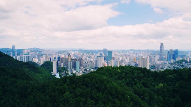 Aerial view of forested hillside and clouds near Guiyang