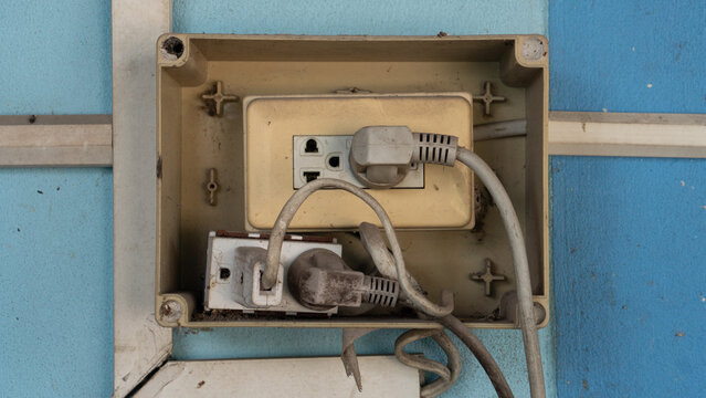 Junction box containing electrical blocks and crisscrossing wires. The missing plastic lid reveals a potentially unsafe and disorganized installation.