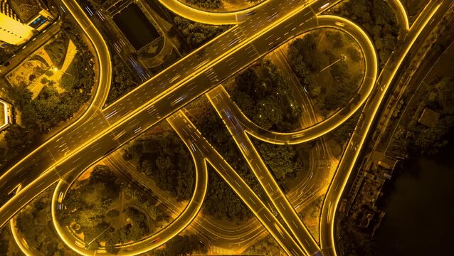 Aerial night traffic on illuminated overpass in Haikou Binhai