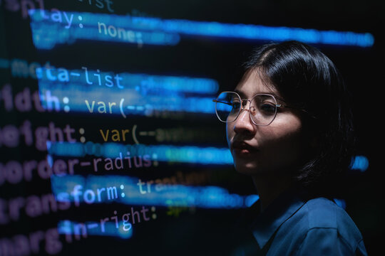 Young coder stares at glowing code screens. Background pulses with programming syntax