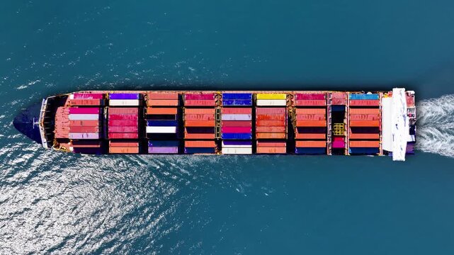 Container ship navigates open waters, delivering goods amidst global supply challenges
