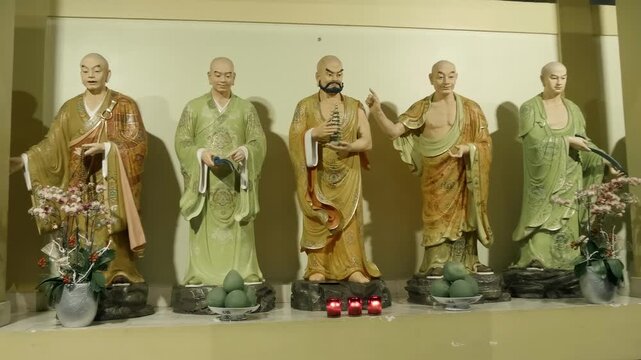 Five standing statues of Buddhist monks, Arhats waring robes inside the Viet Nam Quoc Tu Pagoda (Vietnamese National Pagoda) in Ho Chi Minh
