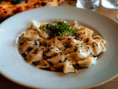 Creamy Pasta Dish Close-Up, Idrija zlikrofi, Dumpling, Gourmet Slovenian Food with Herbs and Sauce